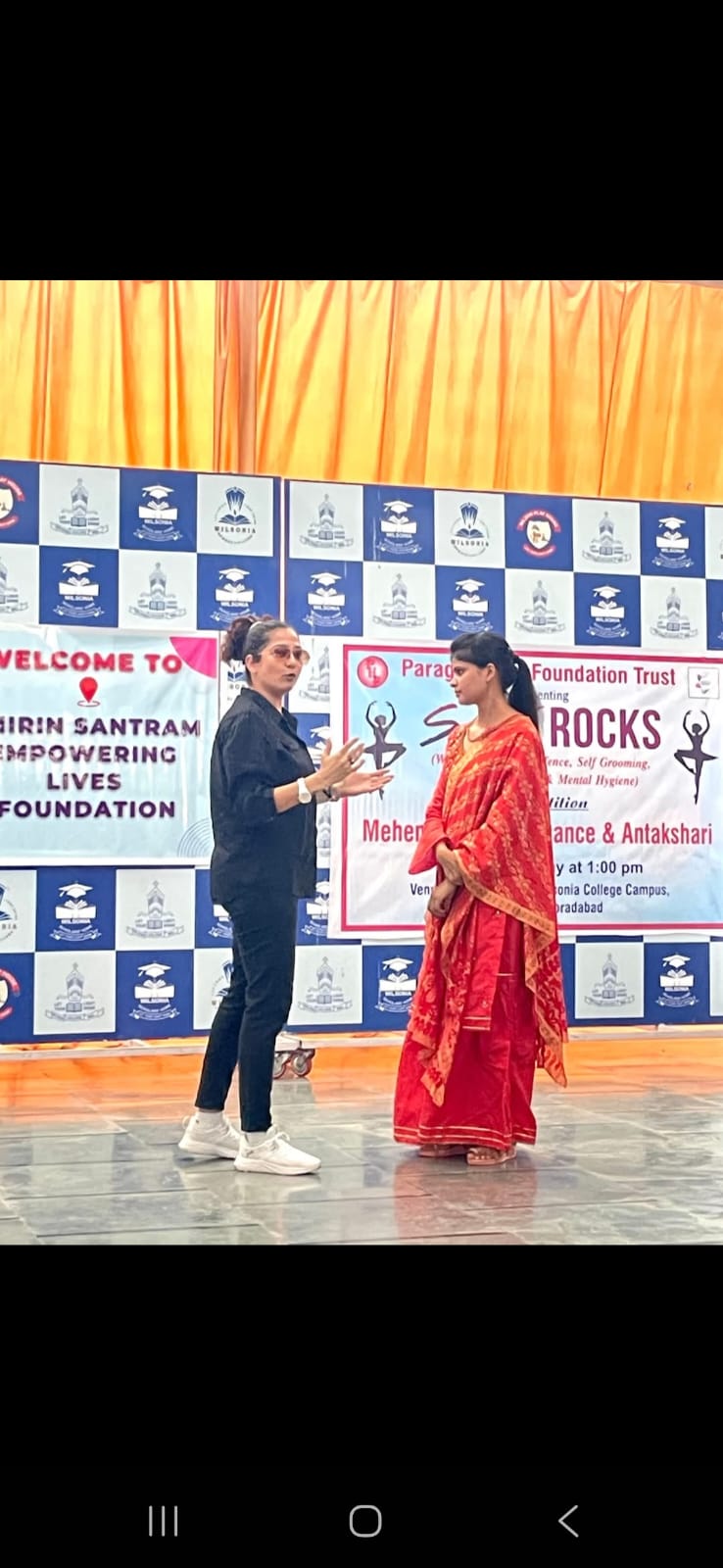 Speaker sharing safety advice with girl student on stage